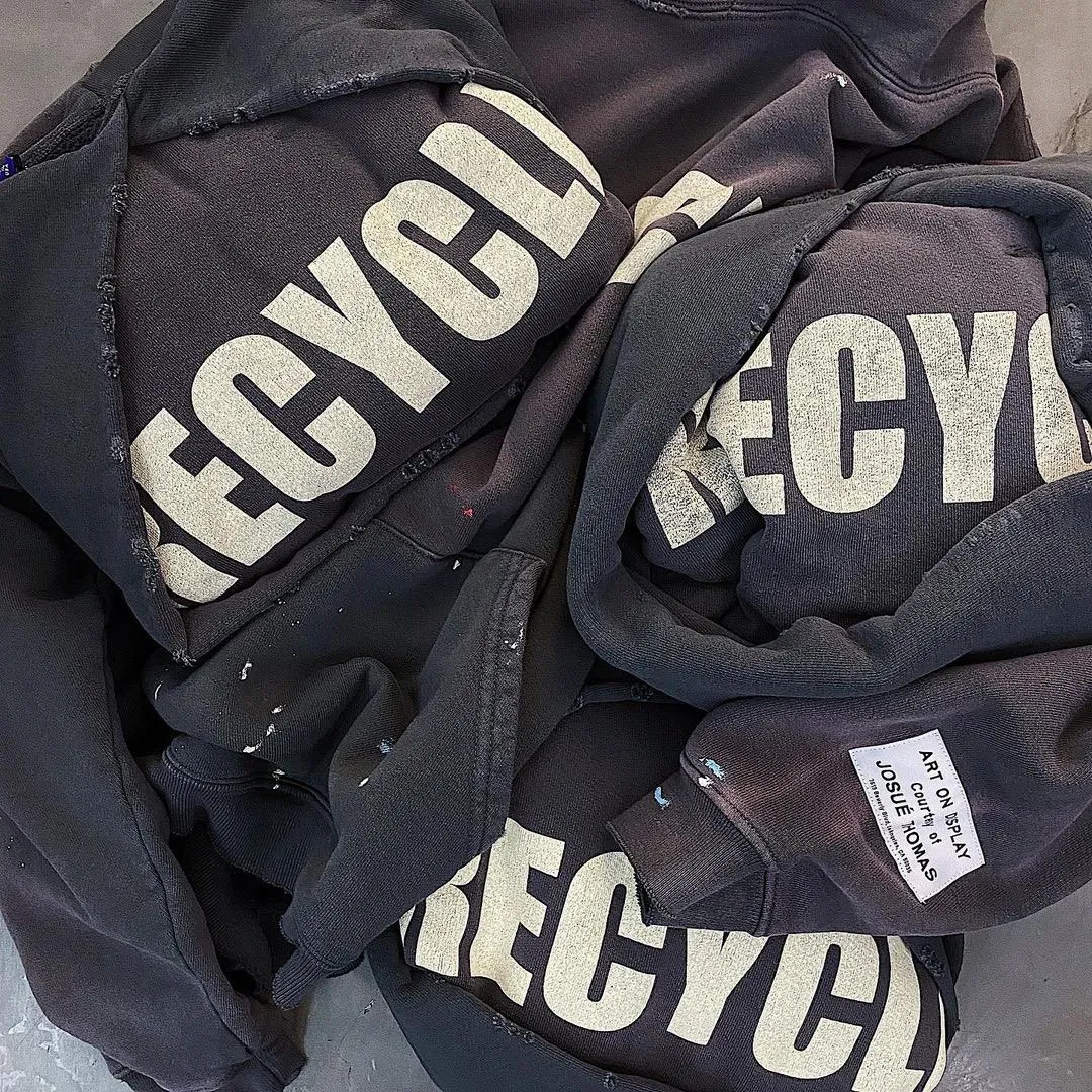 GALLERY DEPT. 90'S RECYCLE HOODIE WASHED BLACK 90'S washed hoodie with distressed eco-friendly slogans. Washed black S-XL. Ready-made garments are washed and dyed again. Multiple spots throughout the body are spray-faded. The ribs are cut and worn.